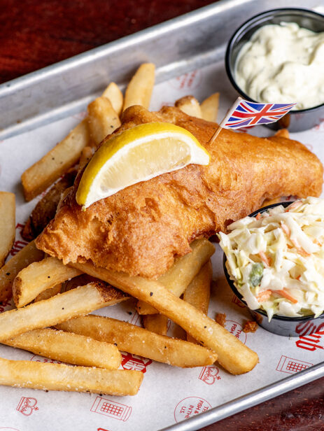 Wee Fish meal from London Street Eats by The Pub at Element Eatery food hall, featuring a crispy fried fish fillet with fries, coleslaw, tartar sauce, and a lemon wedge on a tray lined with custom paper