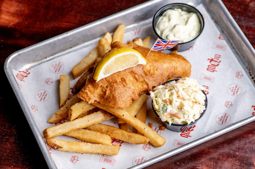 Wee Fish meal from London Street Eats by The Pub at Element Eatery food hall, featuring a crispy fried fish fillet with fries, coleslaw, tartar sauce, and a lemon wedge on a tray lined with custom paper